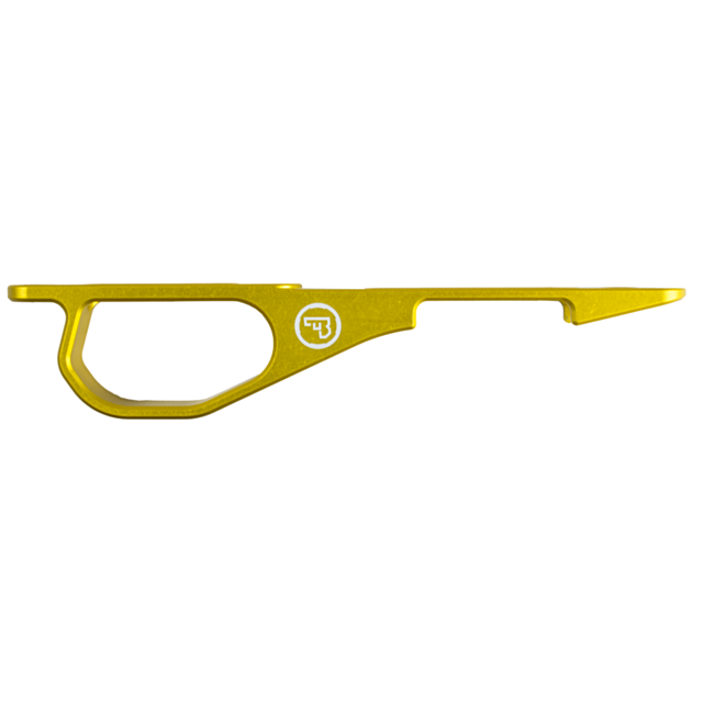 A gold-colored metallic keychain tool with a hooked design, featuring a white circular logo of the CZ 455 Trigger Guard Set.