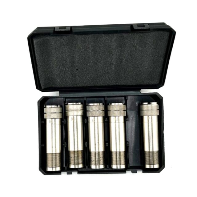 The Ext. Choke Tube Set 12ga Trap (F-IM-M-IC-C) for All American Single Trap comes in a black plastic foam-lined case, holding five metallic threaded tubes with engraved markings, arranged side by side.