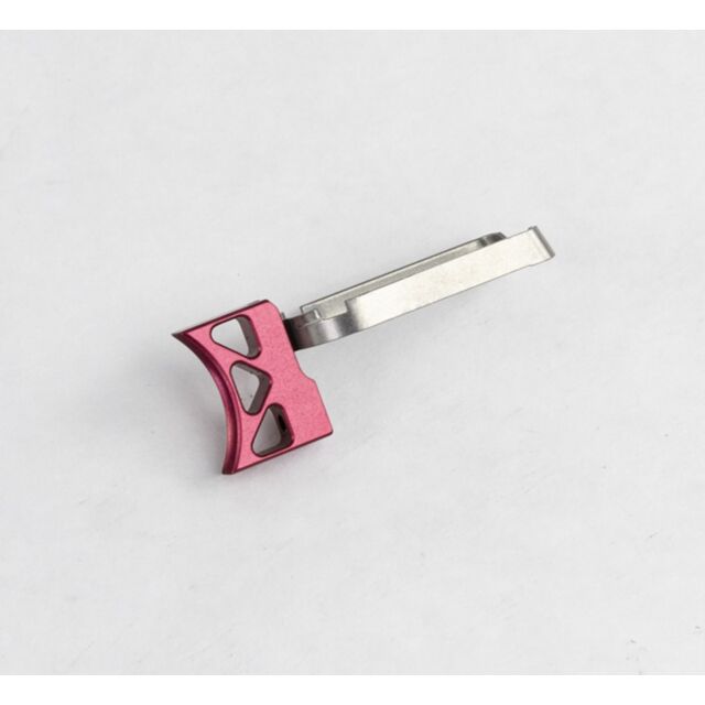 A DWX FULL SIZE TRIGGER ASM, CURVE K in red, featuring a small metal body with a triangular head that has three cut-out sections and an attached silver rectangular strip, is lying on a plain white background.