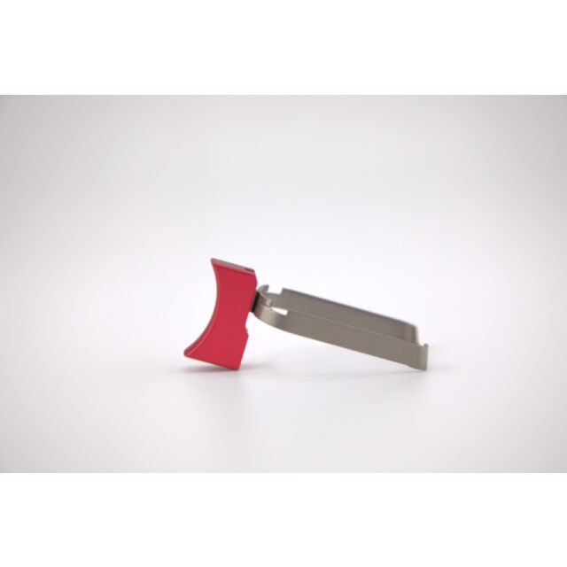 A DWX COMPACT TRIGGER ASM in short curved red design, elegantly mounted on a sleek silver base, is showcased against a plain white background.