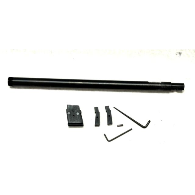 The CZ 457 VARMINT SR BARREL SET, 22LR, 16.5IN NITRIDE includes a rectangular piece, two small blocks, a cylindrical pin, and two L-shaped hex keys, all displayed on a white surface.