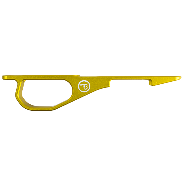 A gold-colored metallic keychain tool with a hooked design, featuring a white circular logo of the CZ 455 Trigger Guard Set.