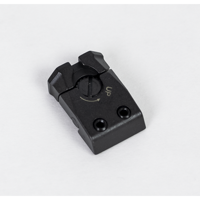 The ADJUSTABLE REAR SIGHT SHADOW 2 is a black mechanical component that has an adjustment dial labeled "UP" and two screw holes. It resembles a rectangular piece with rounded edges, casting a subtle shadow against a white background.
