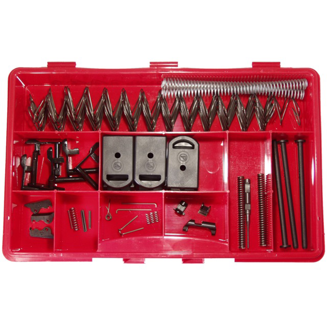 A red plastic organizer neatly arranges springs, levers, and small mechanical components from the SPARE PARTS KIT SP-01 TACTICAL in its various compartments.