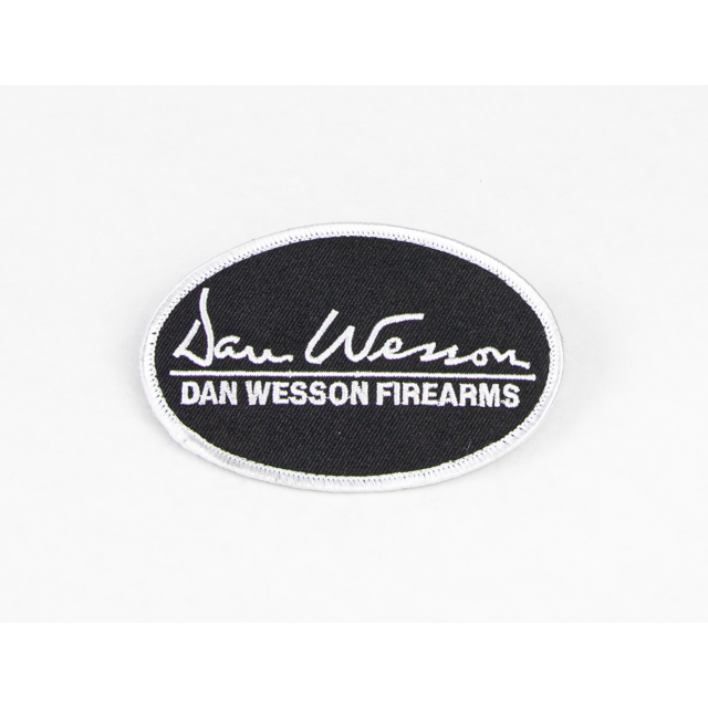 A black oval patch outlined with a white border features the text "Dan Wesson" in cursive, while "DAN WESSON FIREARMS" is prominently displayed below, encapsulating the spirit of this iconic brand in the DAN WESSON PATCH.
