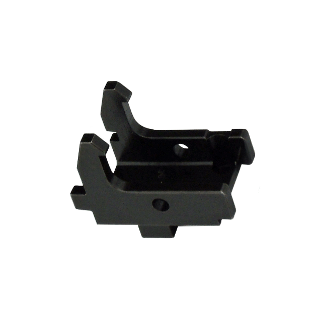TRIGGER HOUSING EVO SEMI features a black metal bracket with angular, sharp-edged design, including two prongs on each side and a central hole. It is ideal for mounting or connecting components as an essential part of semi trigger housing solutions.