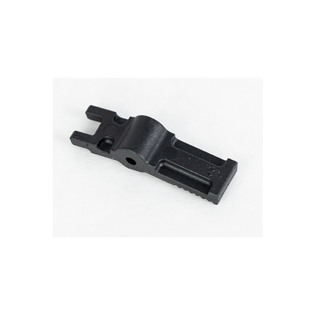 The REAR HEAD DETENT LEVER BREN 2 STOCK, featuring a black plastic or metal construction with a rectangular base, two elevated arms on one end, and a central raised section containing a hole, is positioned against a white background. This suggests its use