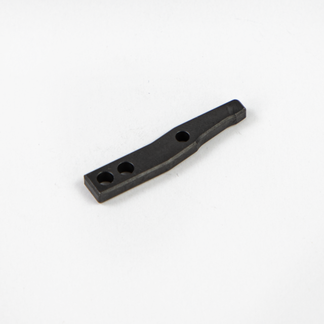 A COCKING LEVER BREN 2, black and made of metal with three holes, is lying on a white background. It features an elongated design with a slightly curved shape.