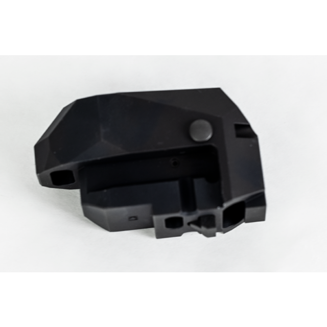 The REAR HEAD ASSEMBLY BREN 2 PISTOL, crafted from black plastic with a geometric design and matte finish, showcases several cutouts and a small protruding button, all set against a white background.