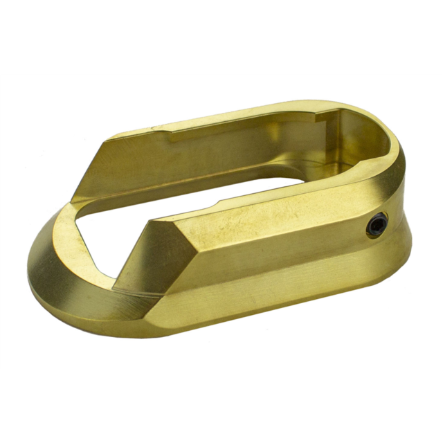 A polished and smooth brass magwell, finished in a metallic gold color with a rectangular opening and beveled edges, mirrors the sleek, angular design of a BRASS MAGWELL SHADOW 2 CZUB component. This sophisticated piece could function as an accessory for