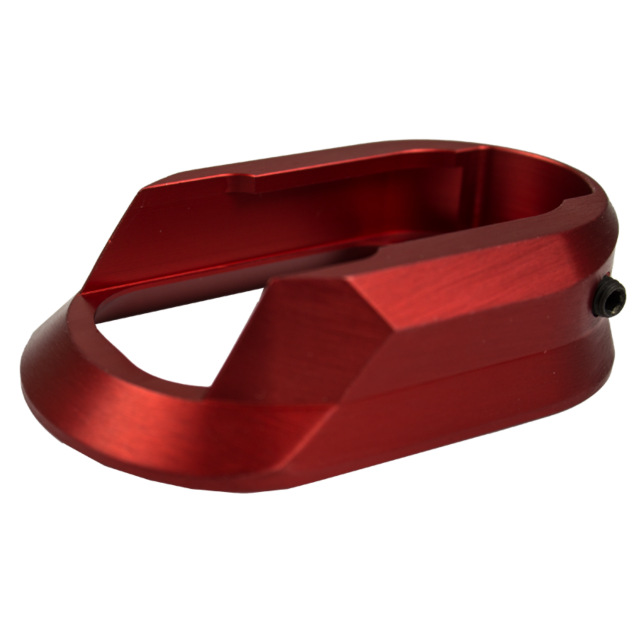 A stylish red metallic component, featuring smooth edges and an open rectangular design, likely the ALUMINUM MAGWELL SHADOW 2 RED for a mechanical or electronic device, casts a delicate shadow on the white background.