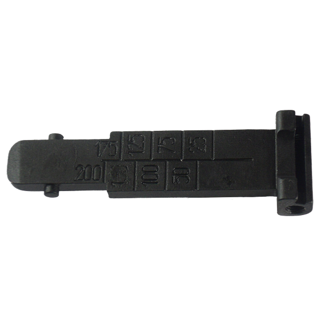 The object is a black, rectangular metal piece called the Tangent Rear Sight Leaf 452/455/457. It features engraved numbers: 15, 25, 50, 75, 100, 125, and 200. Resembling a rear sight leaf for models like the 452/455/457 and includes a notch at the end. I