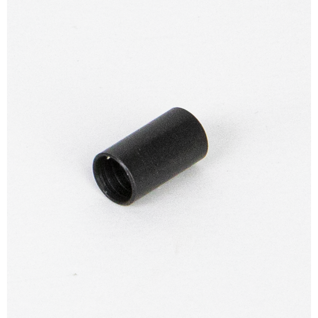 A small black cylindrical object, identified as the FRONT SPACER 550 MAGNUM, lies on a plain white surface. It appears to be made of metal or plastic and is positioned horizontally, displaying its open end.