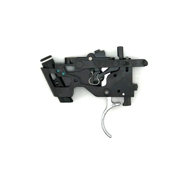 A black Trigger assembly CZ 600, with exposed levers and a metallic trigger, isolated on a white background. It appears to be part of a firearm mechanism.