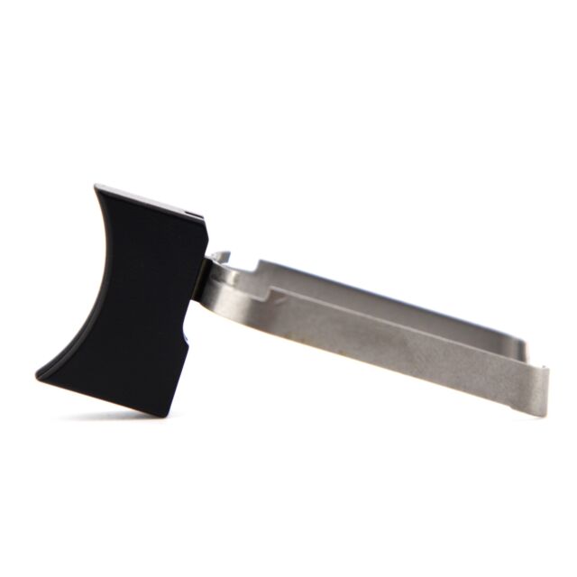 Close-up of a DWX COMPACT TRIGGER ASM, MED. CURVED,BLA, showcasing its metal and black plastic components from a side view. The product features a silver metallic section and a black plastic grip, highlighting its straightforward and practical design agai