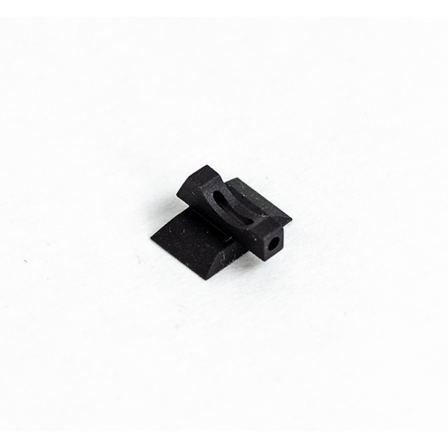 A FRONT SIGHT FIBER OPTIC TARGET .160 in black plastic, featuring a compact design with a curved indentation, is resting on a white surface.