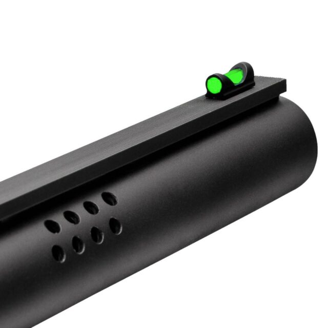 Close-up of a black gun barrel with venting holes and a TRUGLO Green Fat Bead fiber-optic shotgun sight. The green sight is on the upper side of the smooth, matte-texture barrel.